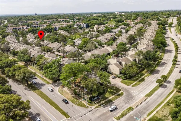 an aerial view of residential houses with city view