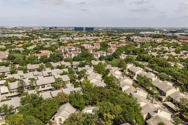 an aerial view of residential house with outdoor space and trees all around