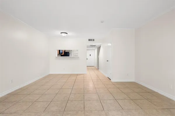 a view of a livingroom with an empty space and a large window