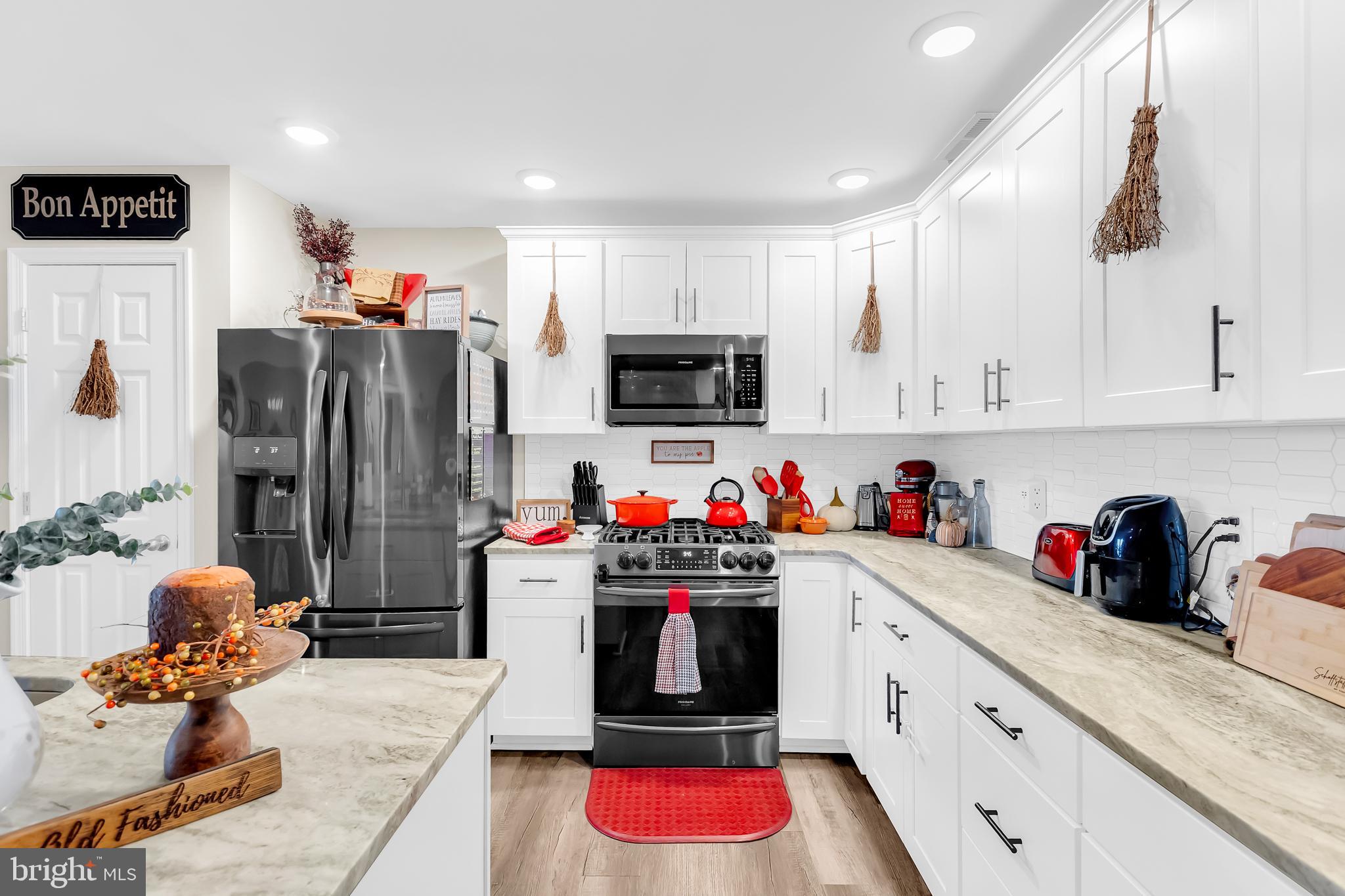 7829 New Hope Road Willards, MD 21874 - Photo 14 of 41 a kitchen with stainless steel appliances a sink cabinets and wooden floor