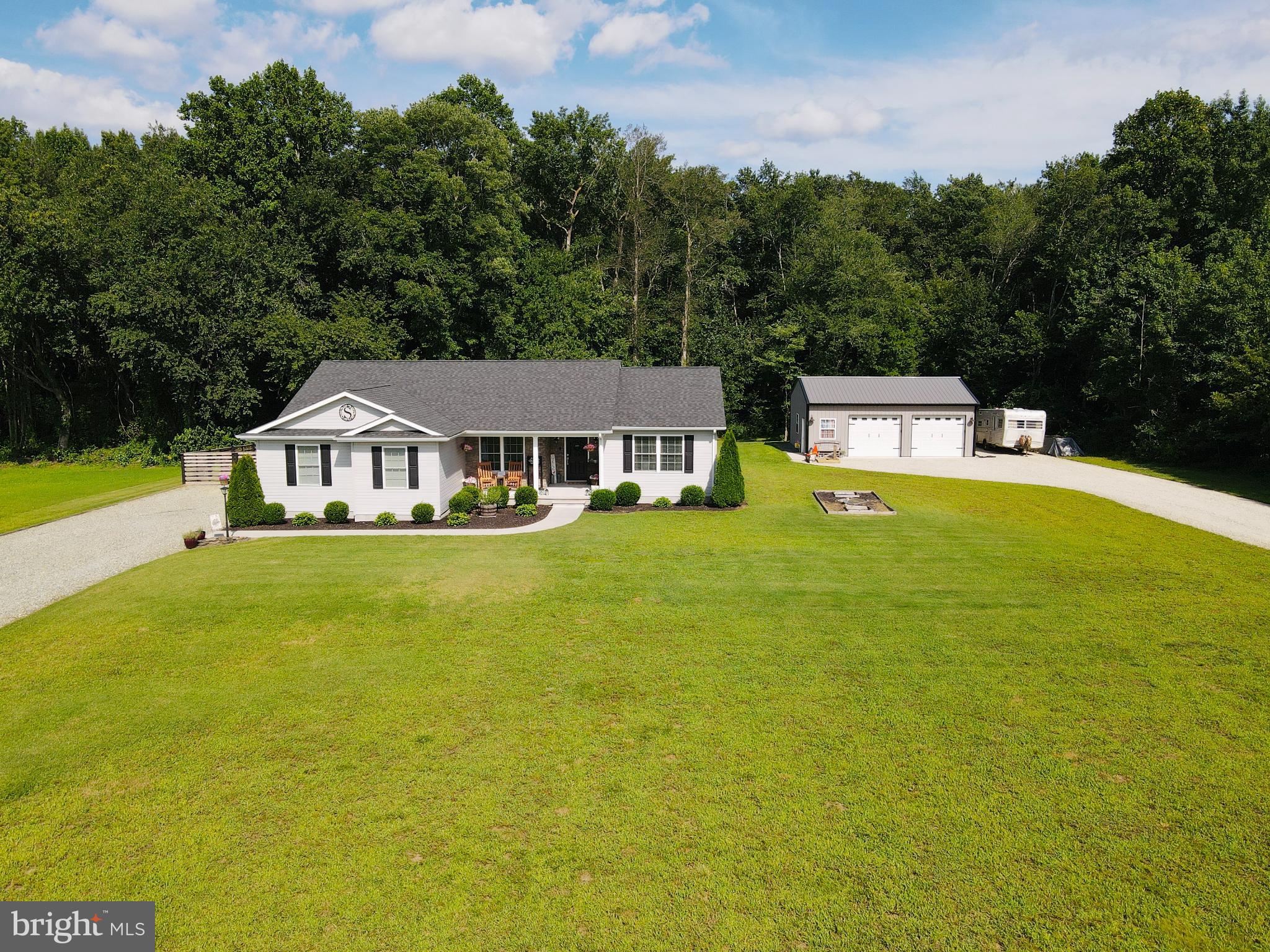 7829 New Hope Road Willards, MD 21874 - Photo 2 of 41 a white house with a large pool in front of house