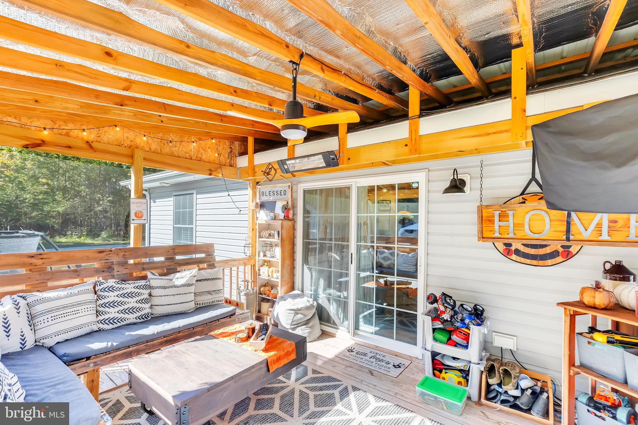 7829 New Hope Road Willards, MD 21874 - Photo 32 of 41 a outdoor space with patio the couches and pool table and chairs