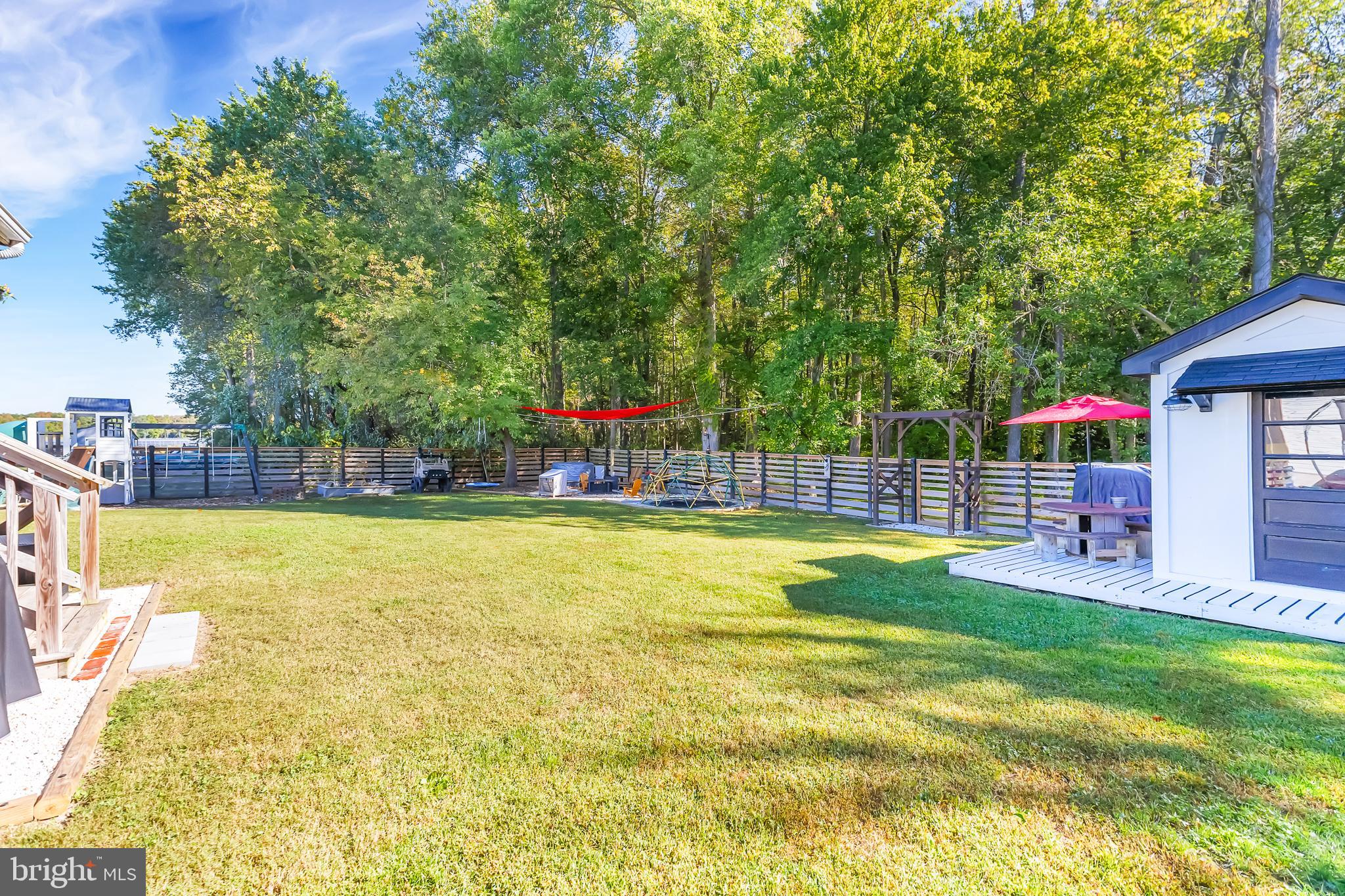 7829 New Hope Road Willards, MD 21874 - Photo 39 of 41 a view of a swimming pool with a lawn chairs and a big yard