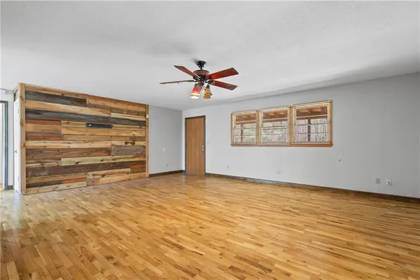 a roof deck with table and chairs and wooden floor