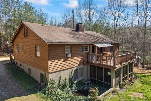 a backyard of a house with barbeque oven table and chairs