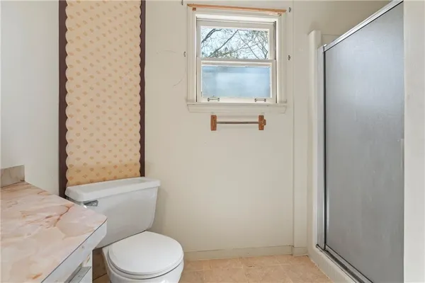 an empty room with a ceiling fan and a window