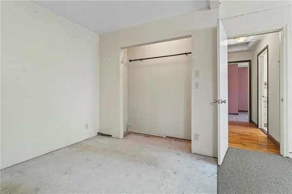 a white toilet sitting next to a shower