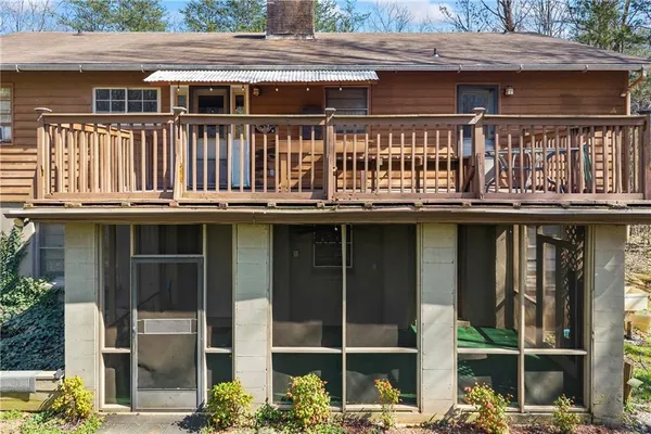 a view of an empty room with wooden floor fireplace and a window