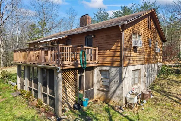 a view of an empty room with a fireplace and a window