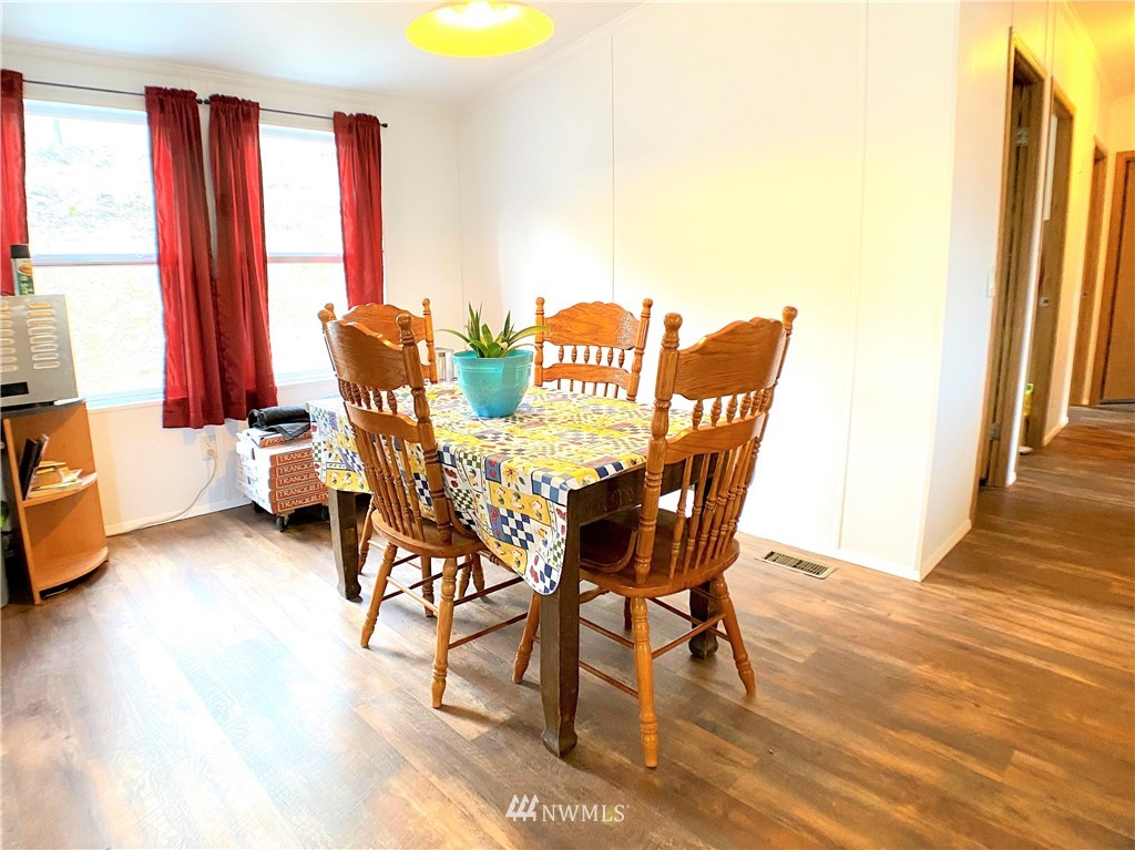 421 Klondike Road Republic, WA 99166 - Photo 3 of 24 a view of a dining room with furniture and wooden floor