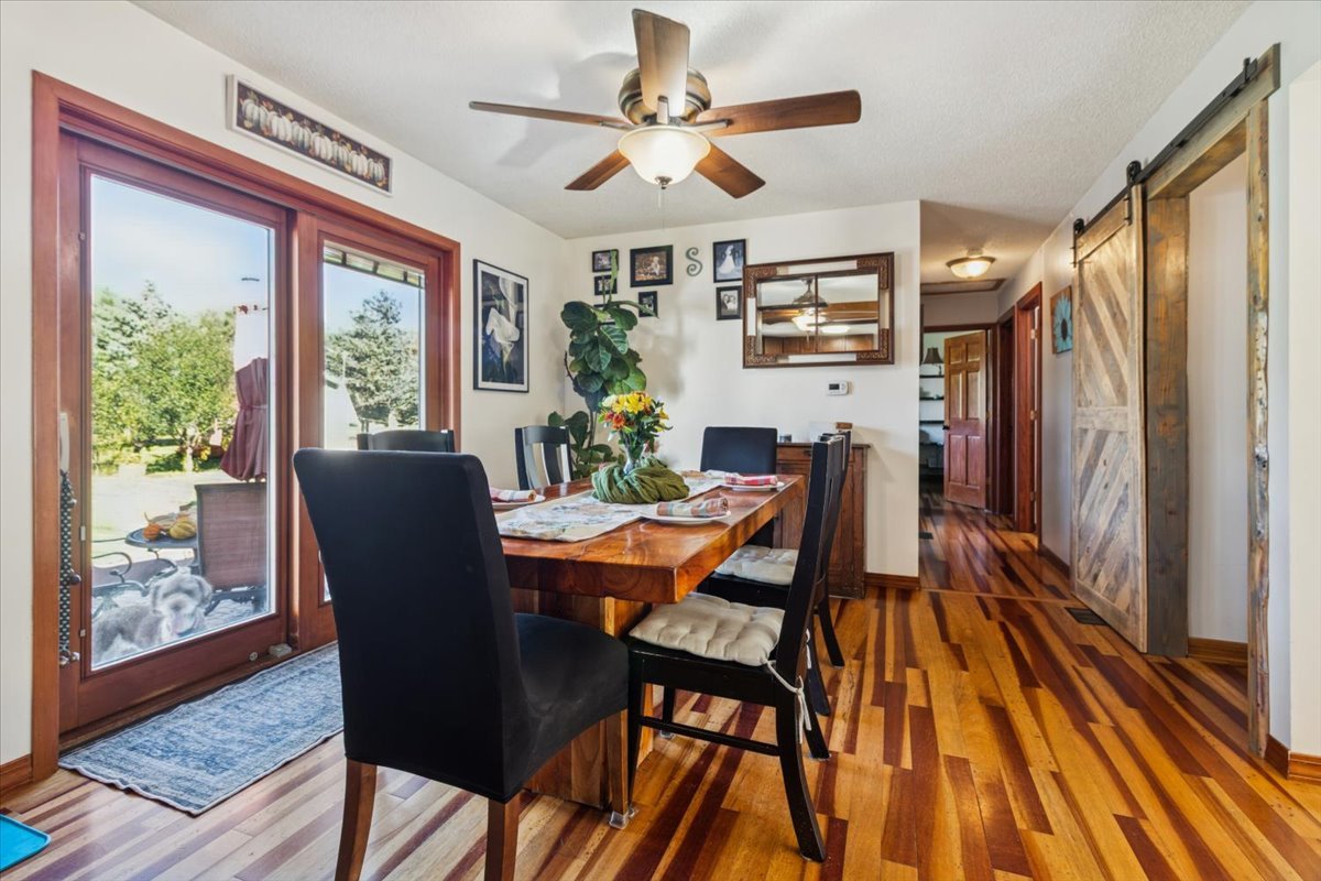 12641 Willow Lane Genoa, IL 60135 - Photo 12 of 29 a dining room with furniture a flat screen tv and a floor to ceiling window