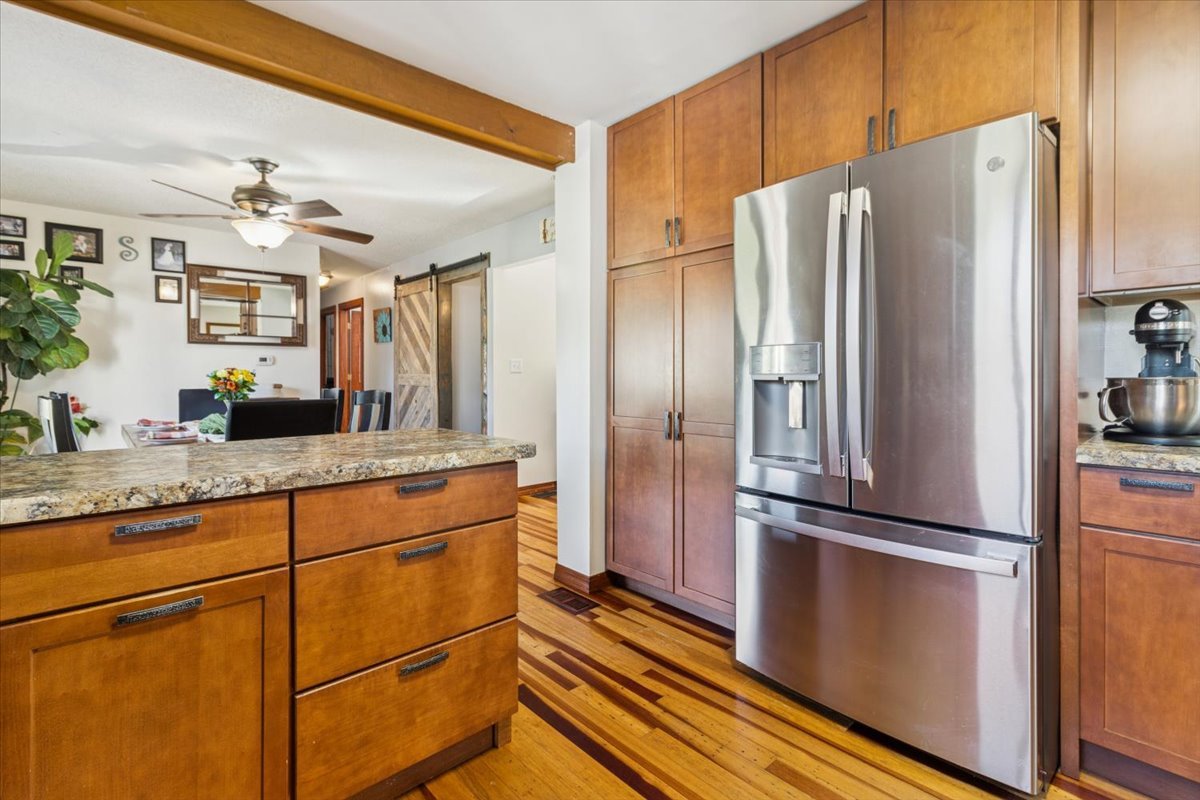 12641 Willow Lane Genoa, IL 60135 - Photo 15 of 29 a kitchen with granite countertop a refrigerator and a sink
