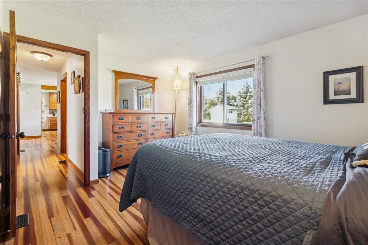 12641 Willow Lane Genoa, IL 60135 - Photo 18 of 29 a bedroom with a bed and wooden floor