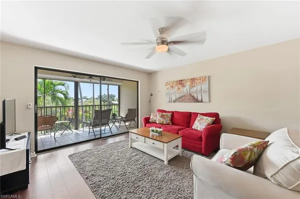 a living room with furniture or couch and a floor to ceiling window