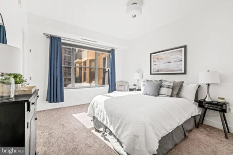 a bedroom with a large bed and a window