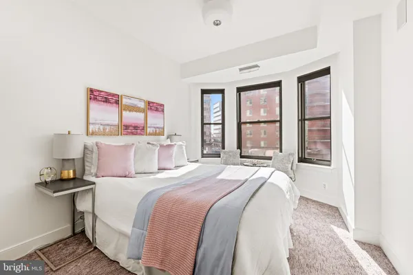 a bedroom with a bed and a window