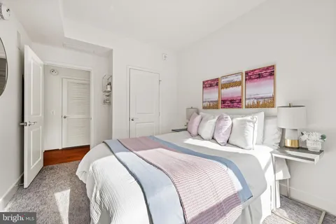 a bedroom with a bed and a mirror
