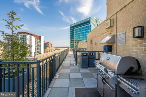 a view of a roof deck with furniture