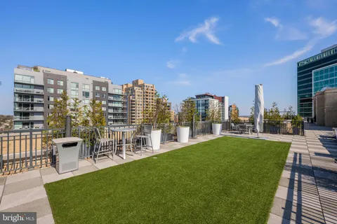 a view of a city with tall buildings and a big yard