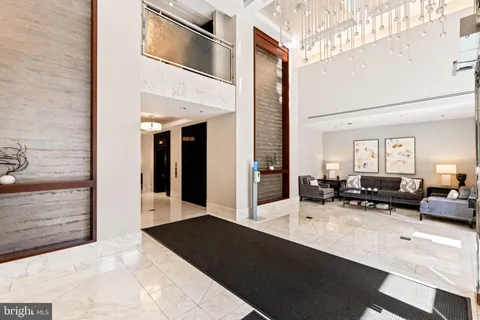 a lobby with furniture and rug