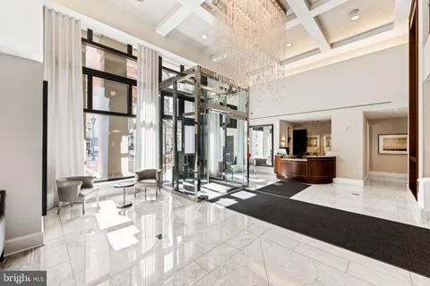 a lobby with furniture and floor to ceiling window