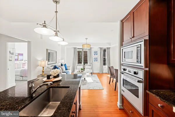 a very nice looking living room with a large window and chandelier