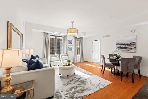 a living room with furniture and a dining table