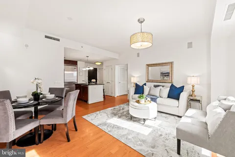 a living room with furniture kitchen view and a dining table