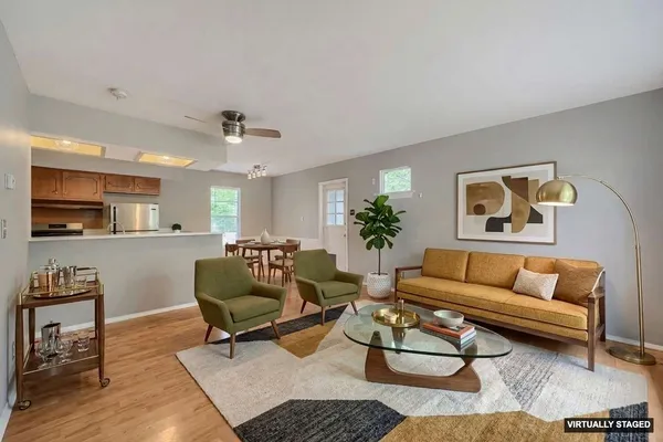 a living room with furniture and wooden floor