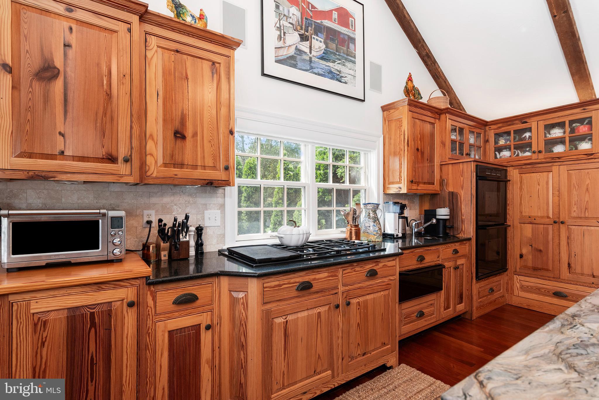 7989 Quaker Neck Road Chestertown, MD 21620 - Photo 25 of 90 a kitchen with stainless steel appliances granite countertop a stove a sink and a microwave