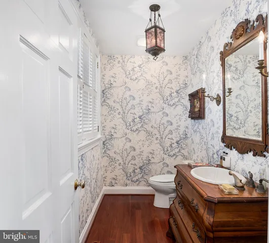 a bedroom with a bed and a lamp on dresser