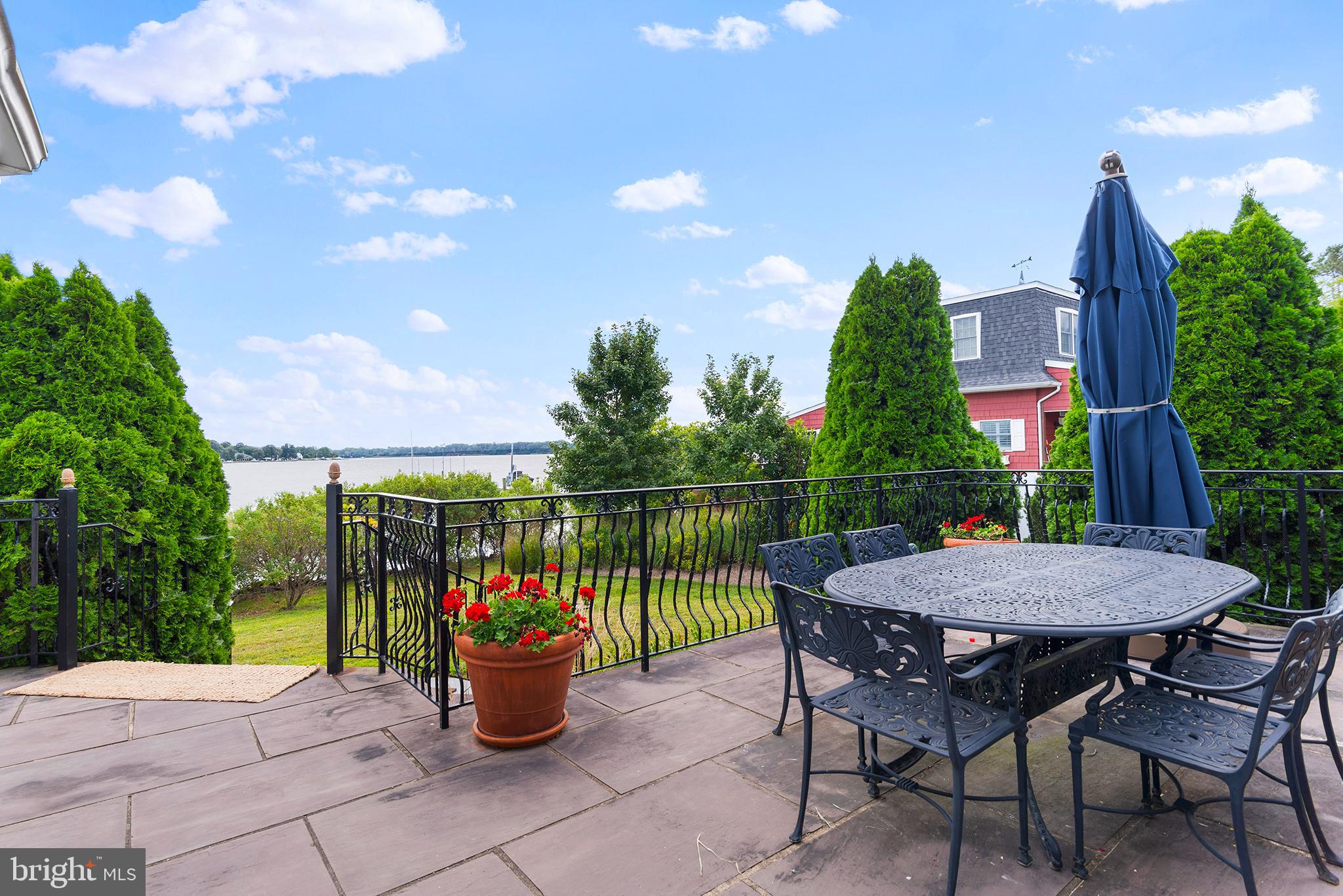 7989 Quaker Neck Road Chestertown, MD 21620 - Photo 40 of 90 a view of a patio with couches and table and chairs and floor to ceiling window