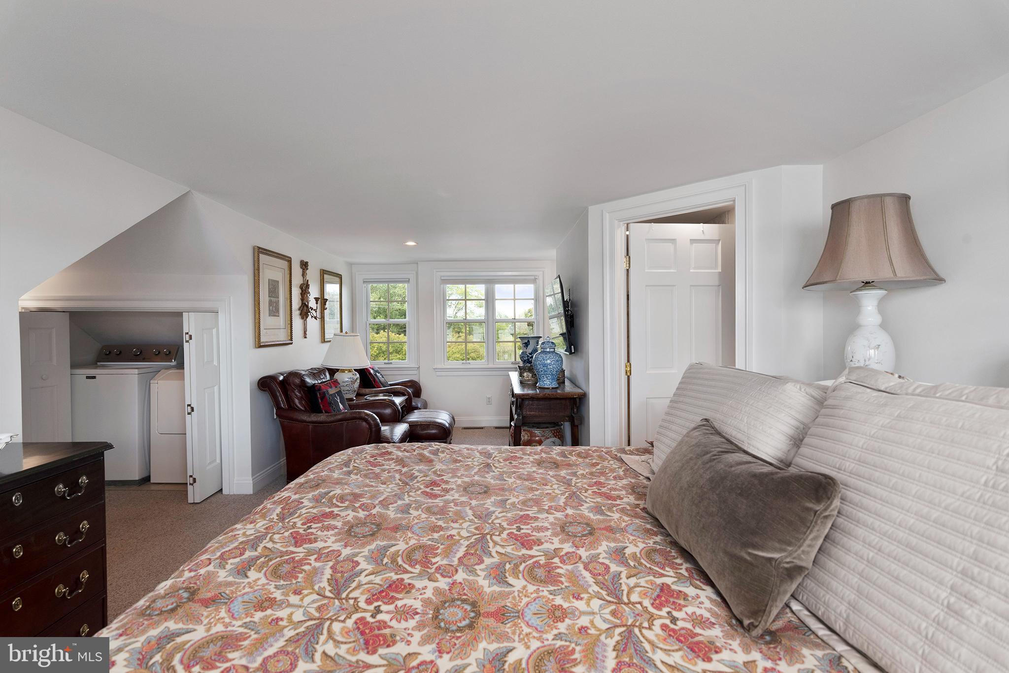 7989 Quaker Neck Road Chestertown, MD 21620 - Photo 58 of 90 a bedroom with a bed and a lamp on dresser