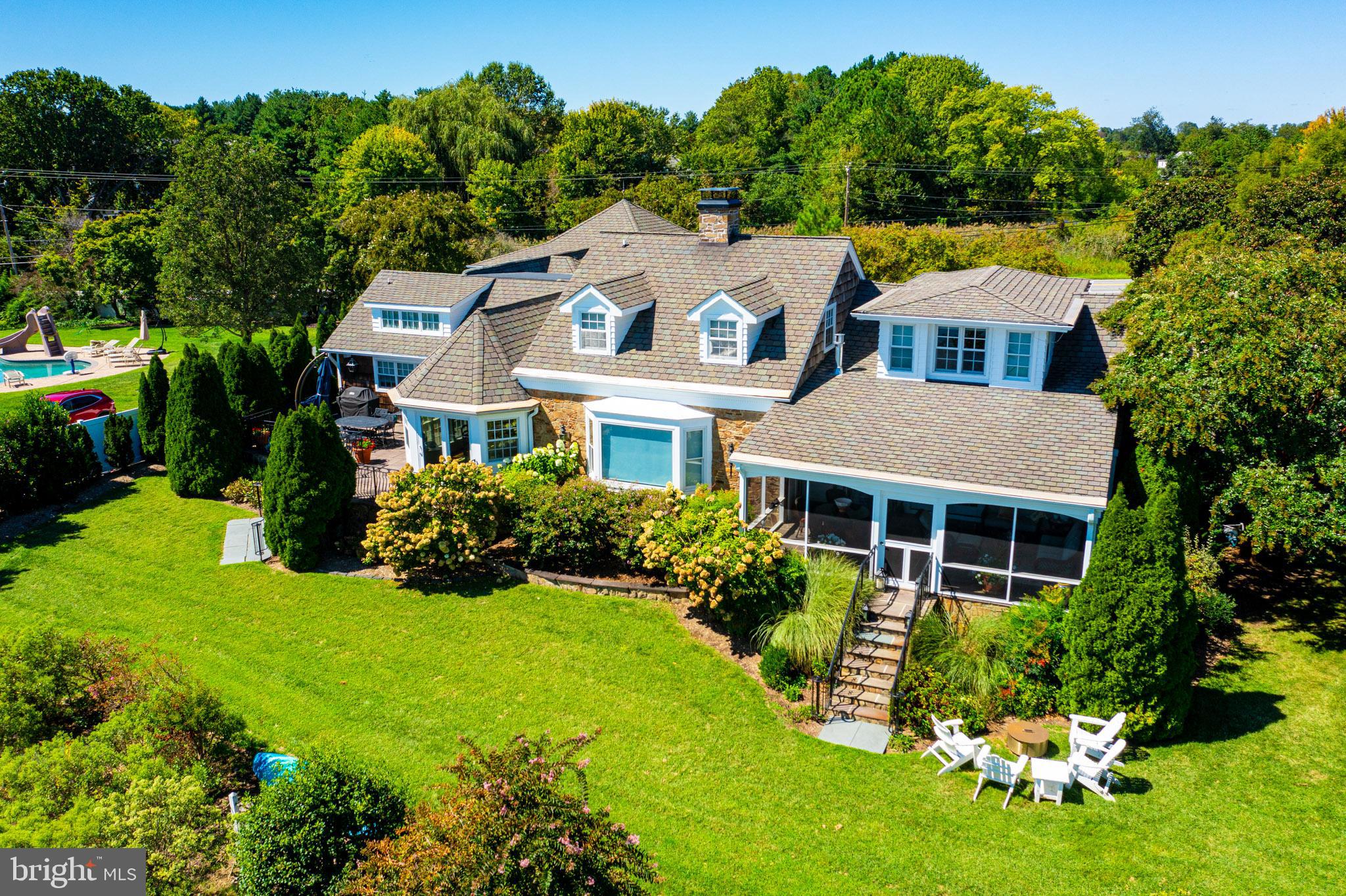 7989 Quaker Neck Road Chestertown, MD 21620 - Photo 89 of 90 a aerial view of a house with a yard table and chairs