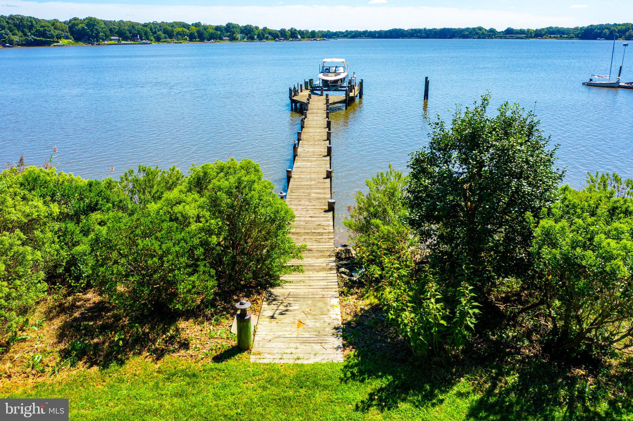 7989 Quaker Neck Road Chestertown, MD 21620 - Photo 10 of 90 a view of a lake with a building in the background