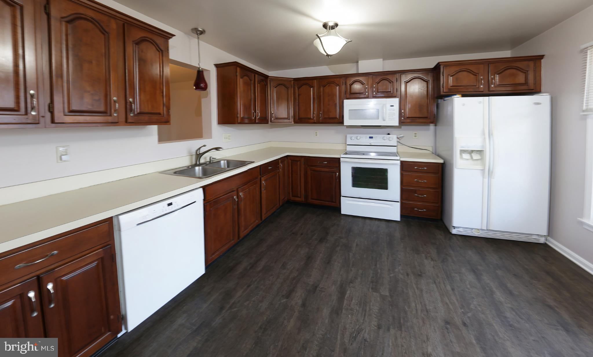 2017 C Raleigh Road Hummelstown, PA 17036 - Photo 12 of 36 Spacious kitchen with rich wooden cabinetry.
