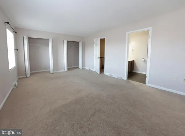 a view of empty room with closet and natural light