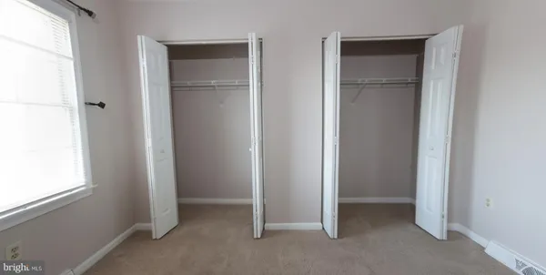 a view of an empty room and closet area
