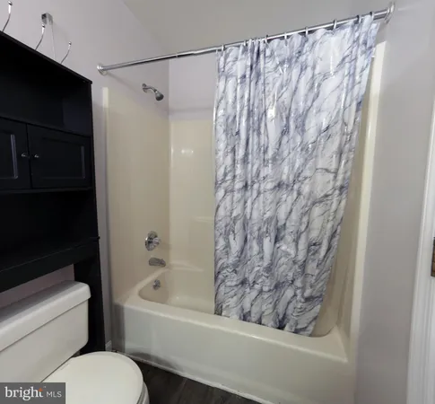 a bathroom with a bathtub and shower