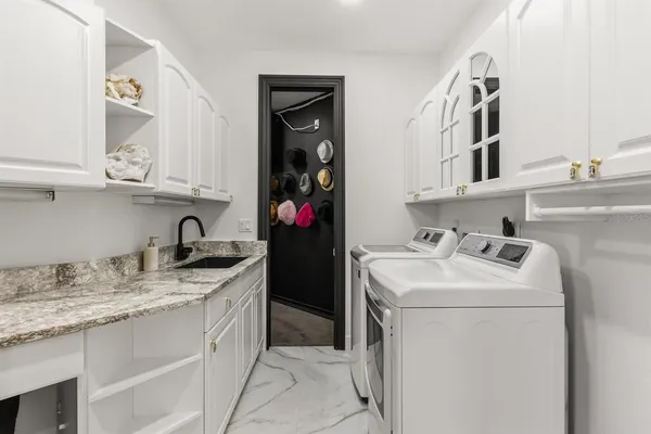 a bathroom with a double vanity sink mirror and shower