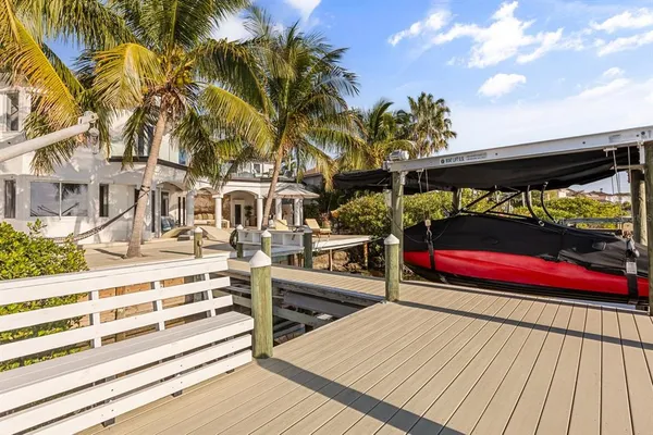 a view of balcony with chairs and wooden fence