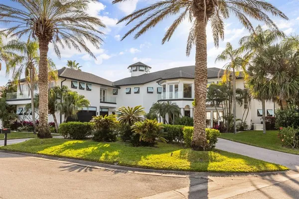 a front view of a house with a garden and yard