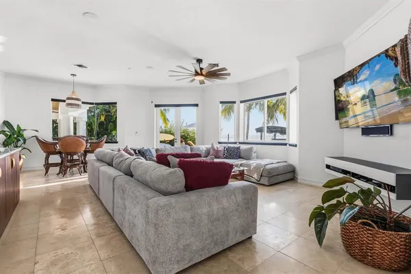 a living room with furniture and a view of kitchen