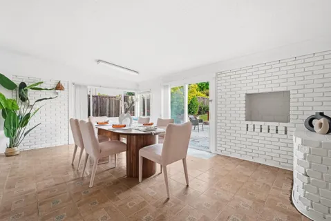 a dining room with furniture and window