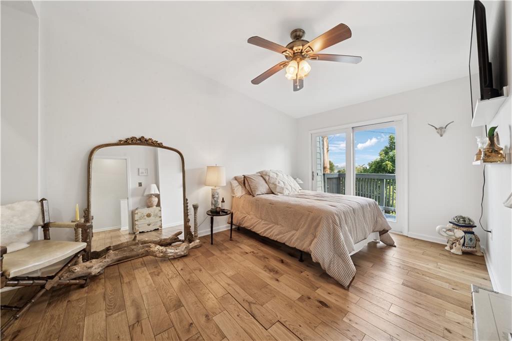 154 Henderson Street Pittsburgh, PA 15212 - Photo 14 of 31 a spacious bedroom with a bed a chandelier and glass door