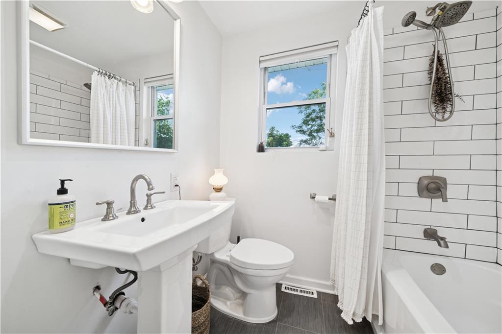 154 Henderson Street Pittsburgh, PA 15212 - Photo 18 of 31 a bathroom with a sink a toilet and shower