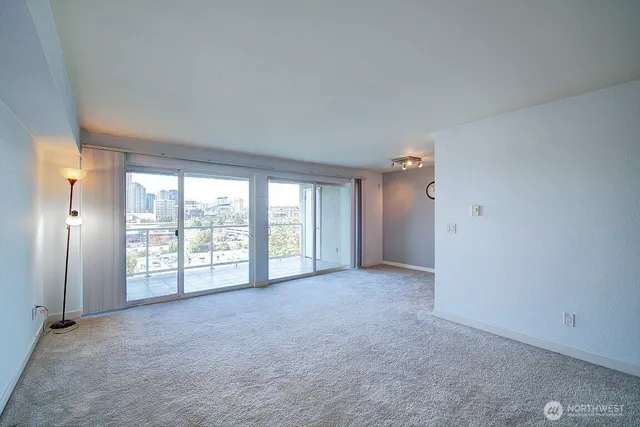 an empty room with a fireplace and cabinet