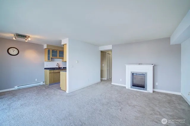 an empty room with a fireplace and fan