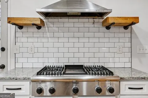 a stove top oven sitting inside of a kitchen