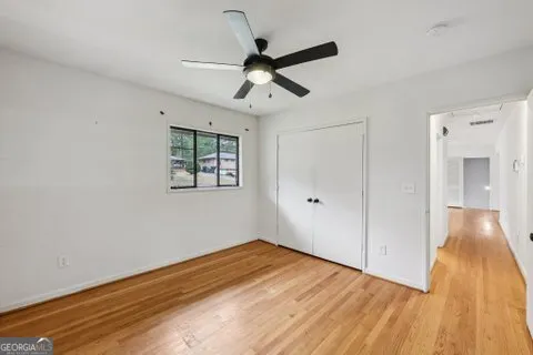 a view of empty room with wooden floor